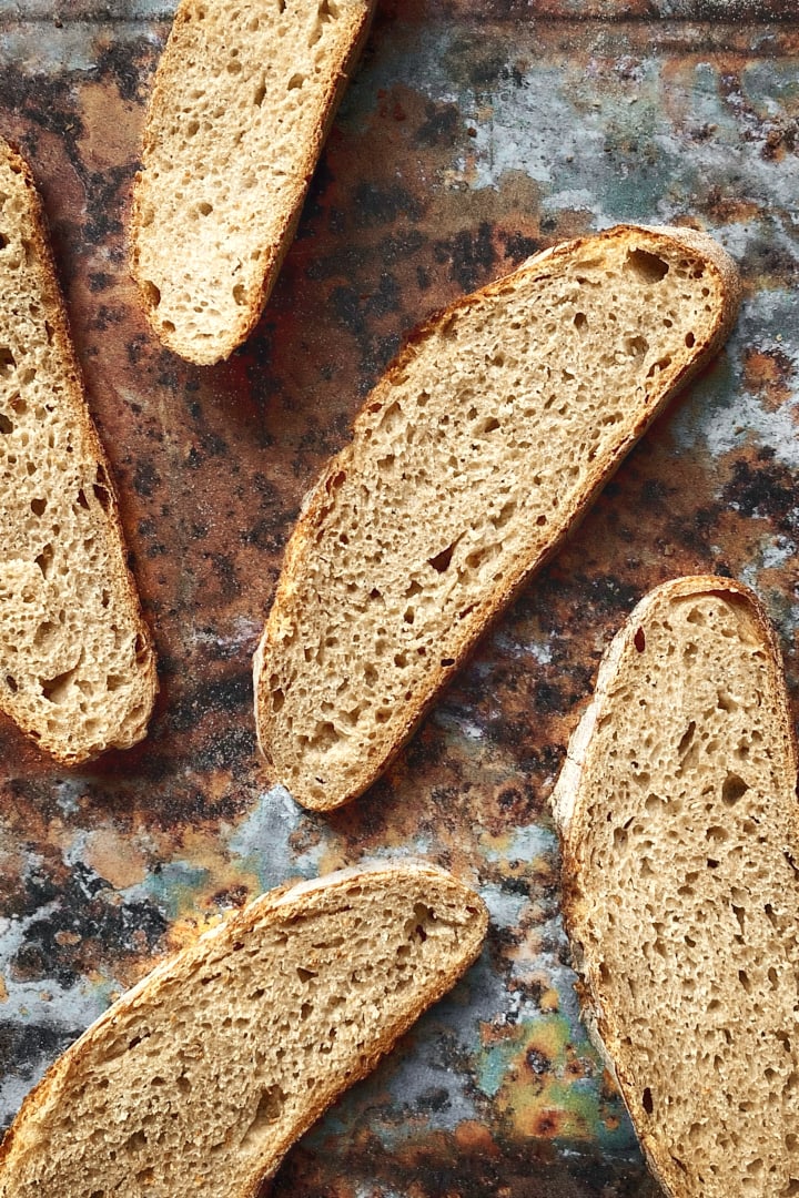 Slices of spelt bread on a rustic backdrop.