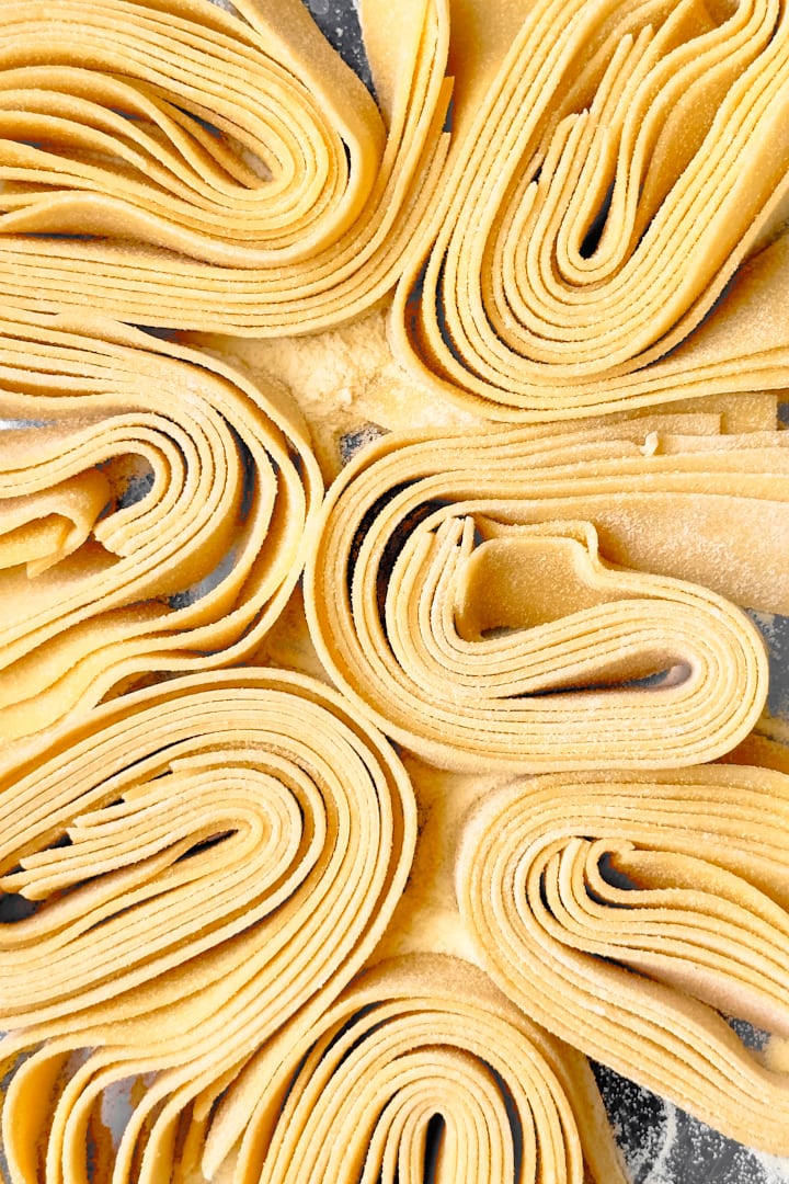 Fresh pappardelle pasta twirled together into pasta nests.