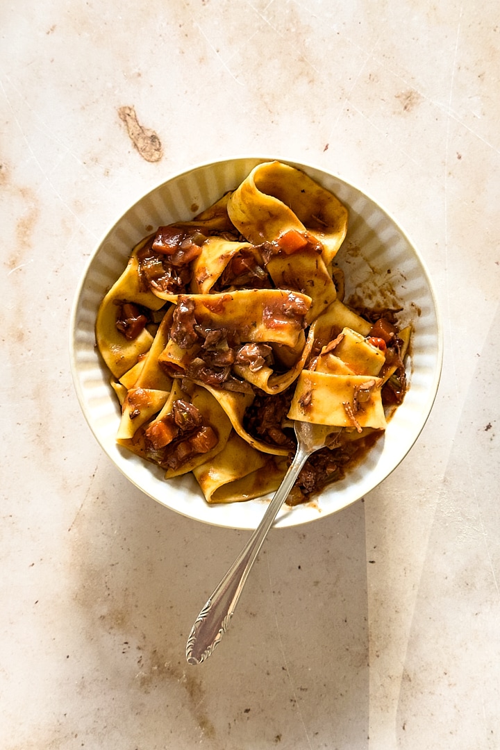 A bowl of homemade pappardelle pasta served with slow cooked lamb ragu.