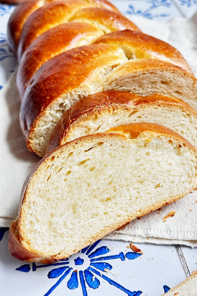 Soft and sweet braided sourdough bread cut into slices.