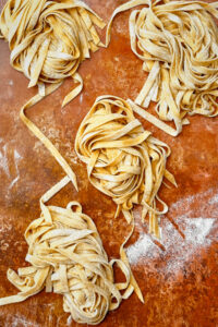 Four pasta nests of homemade tagliatelle.