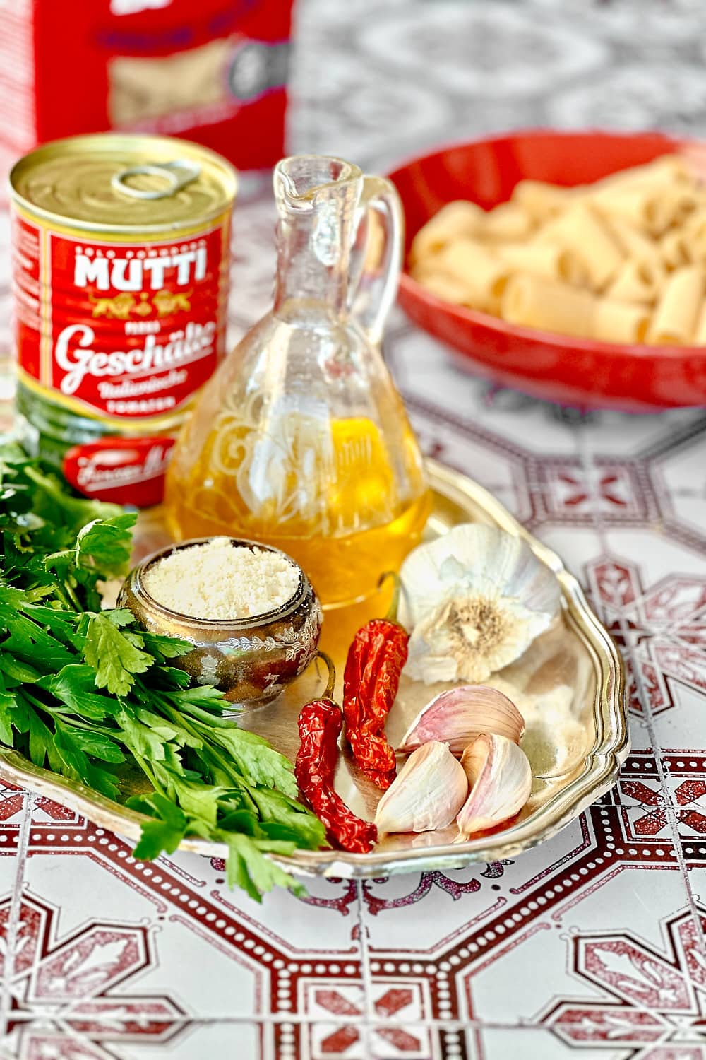 A silver tray with the ingredients to make rigatoni arrabbiata.