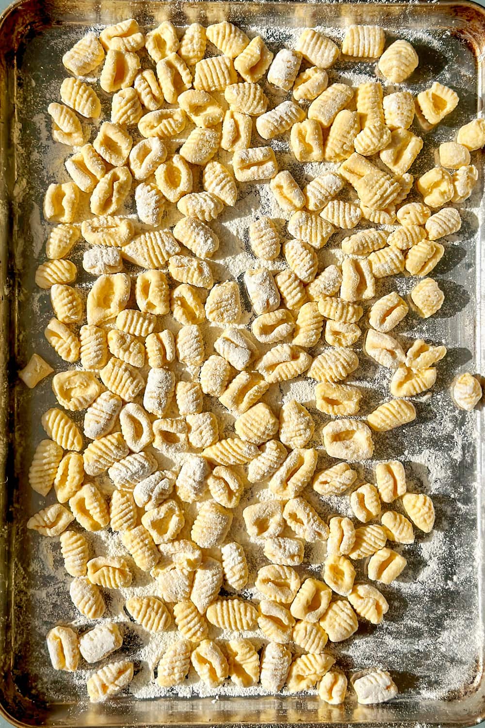 Homemade gnocchi on a baking tray.