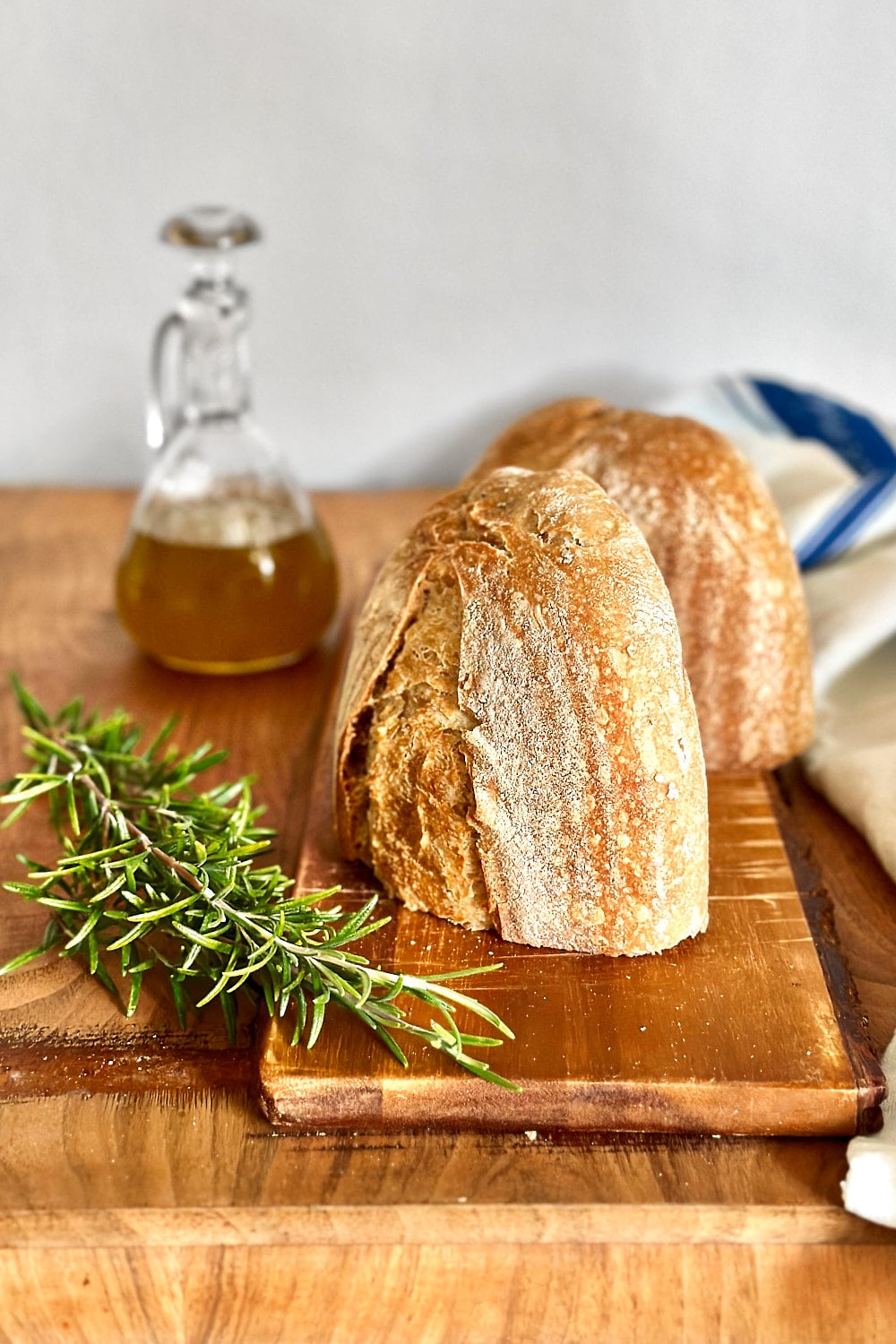 A loaf of rosemary sourdough bread cut in half.