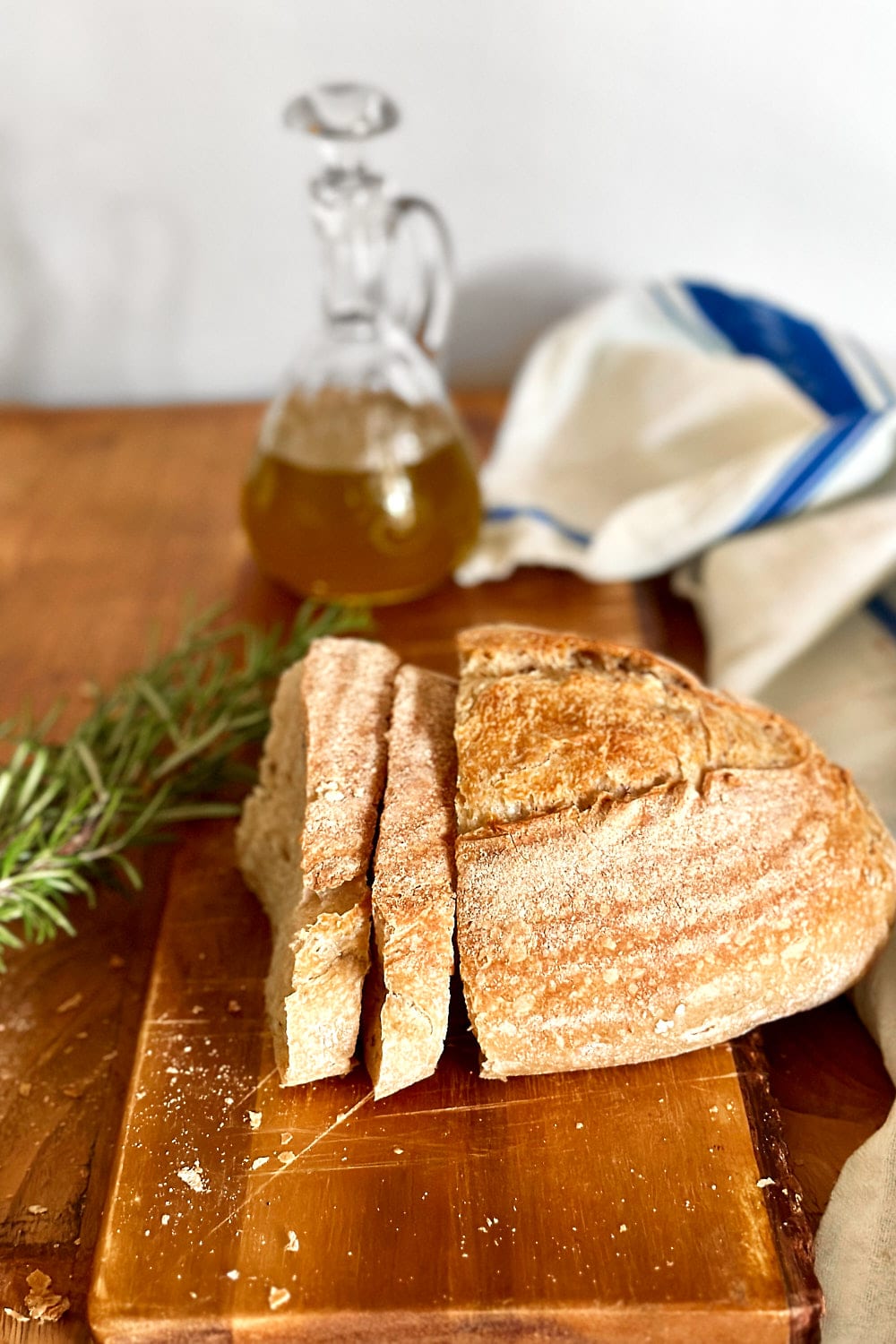 A sliced loaf of freshly baked rosemary sourdough bread.