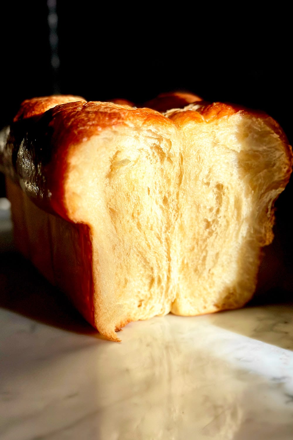 The soft crumb of a freshly baked sourdough brioche.