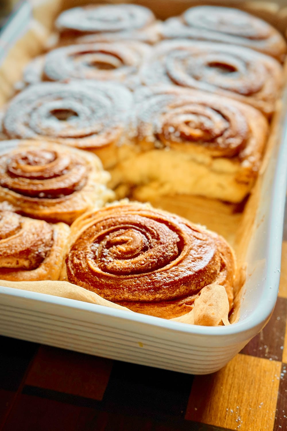Close-up of a baking dish with freshly baked sourdough cinnamon buns.