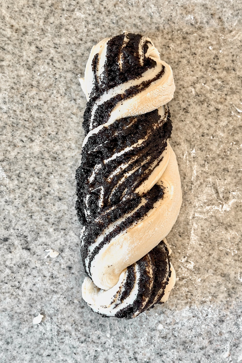 Twisting two dough strands together to shape a babka.
