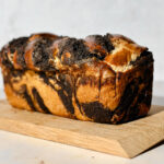 A freshly baked golden brown loaf of poppy seed sourdough babka.